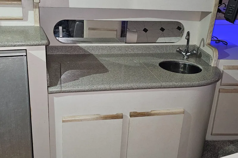 Slide: The Image of 1994 Blackfin 33 Combi boat interior with compact kitchenette and sink. - 28