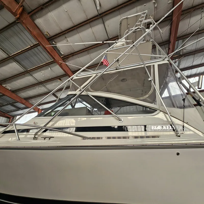 Slide: The Image of 1994 Blackfin 33 Combi boat in a warehouse, showcasing its structure and design. - 3