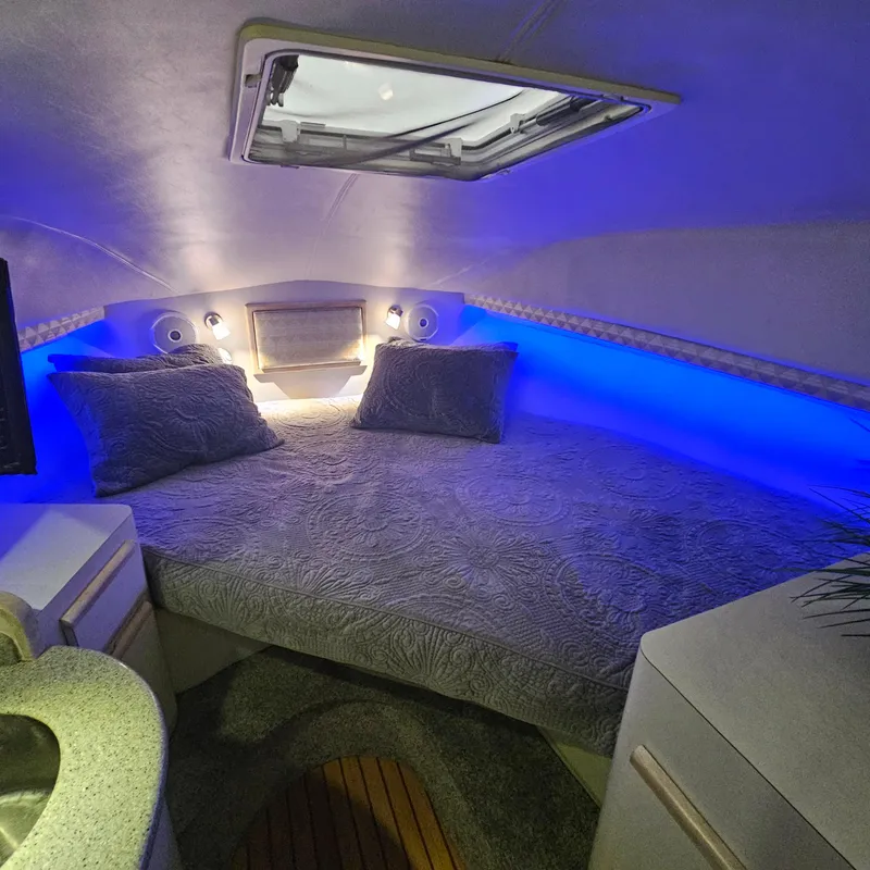 Slide: The Image of Cozy cabin interior of 1994 Blackfin 33 Combi with blue ambient lighting. - 31