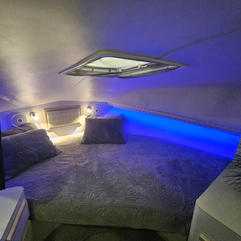Slide: The Image of Cozy cabin interior of 1994 Blackfin 33 Combi with ambient blue lighting. - 32