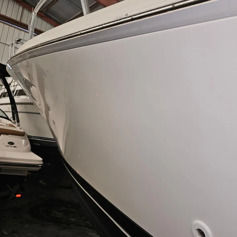 Slide: The Image of 1994 Blackfin 33 Combi boat in storage, showcasing sleek white hull design. - 33