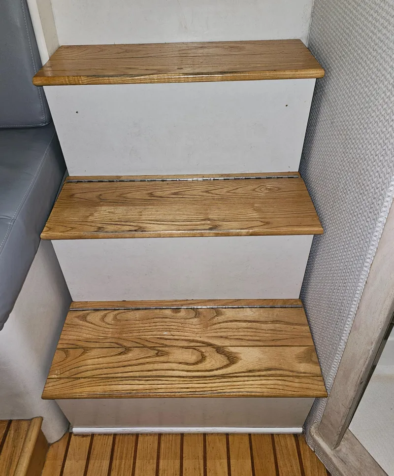 Slide: The Image of Wooden steps inside a 1994 Blackfin 33 Combi boat, featuring a simple, compact design. - 34