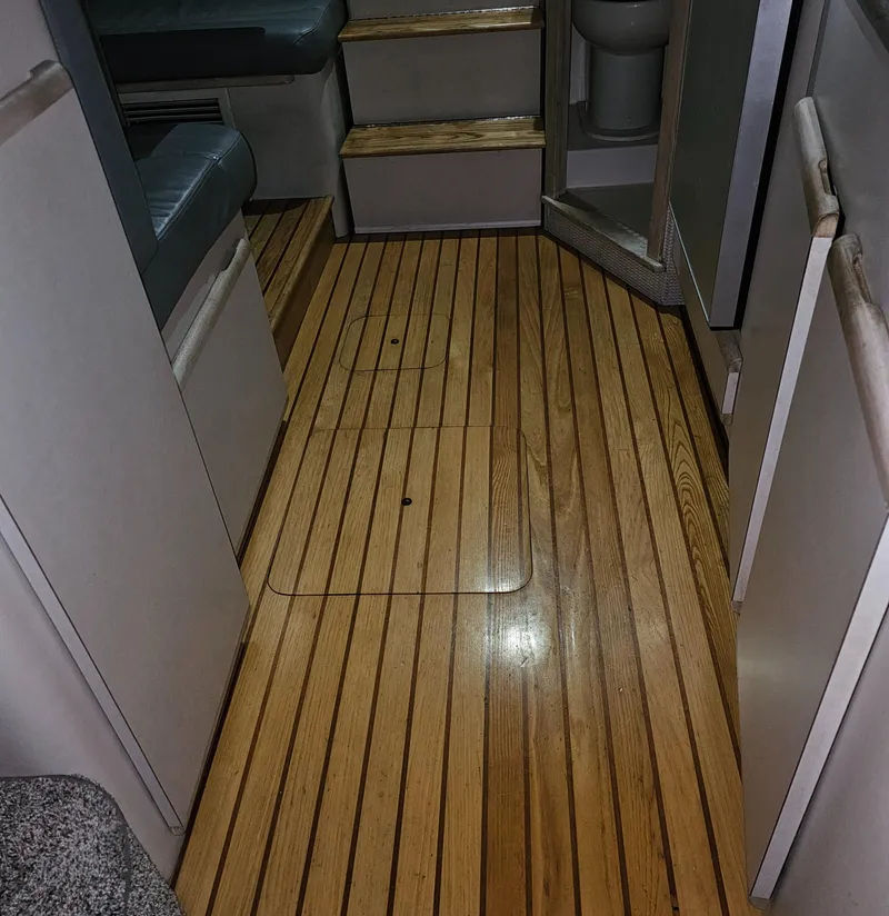 Slide: The Image of Interior of 1994 Blackfin 33 Combi boat with wooden flooring and seating area. - 35