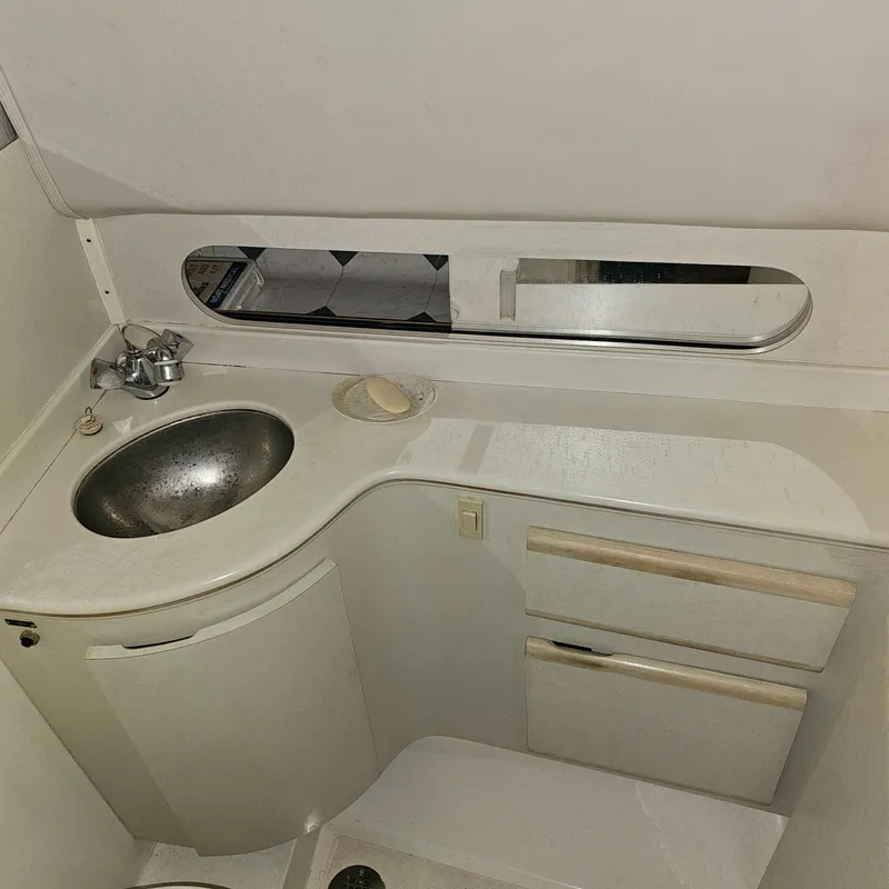 Slide: The Image of 1994 Blackfin 33 Combi boat interior with sink and storage cabinets. - 38