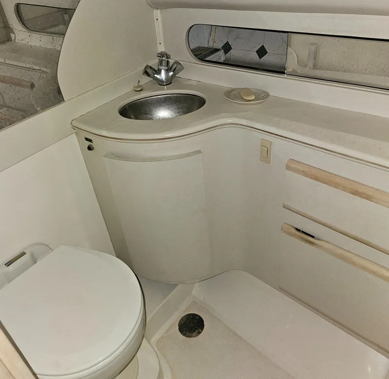 Slide: The Image of 1994 Blackfin 33 Combi boat bathroom with sink, toilet, and storage cabinets. - 39