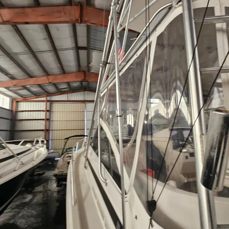 Slide: The Image of 1994 Blackfin 33 Combi boat in storage, side view, under metal roof. - 4