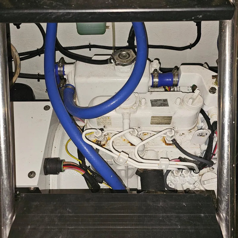 Slide: The Image of Engine compartment of a 1994 Blackfin 33 Combi with visible blue hoses. - 47
