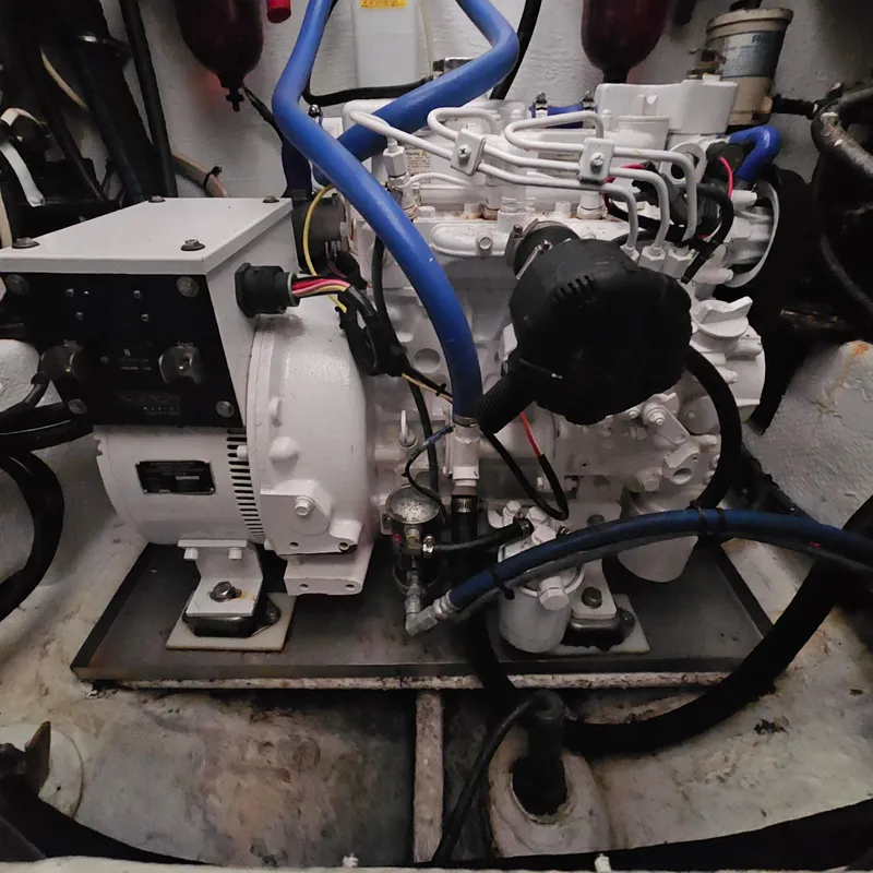 Slide: The Image of Engine room of a 1994 Blackfin 33 Combi boat, featuring mechanical components and wiring. - 48