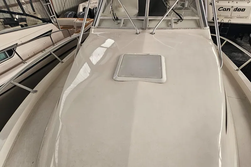Slide: The Image of 1994 Blackfin 33 Combi boat deck with hatch, docked indoors. - 5