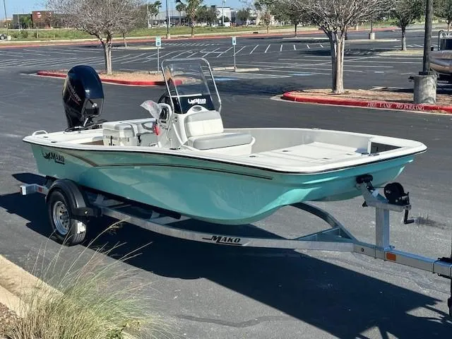Slide: The Image of 2025 Mako Pro Skiff 15 CC boat on trailer in parking lot. - 1