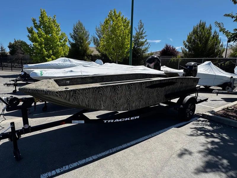 The Image of 2025 Tracker Grizzly 1650 T Prairie Wings Edition boat on trailer, parked outdoors. - 0