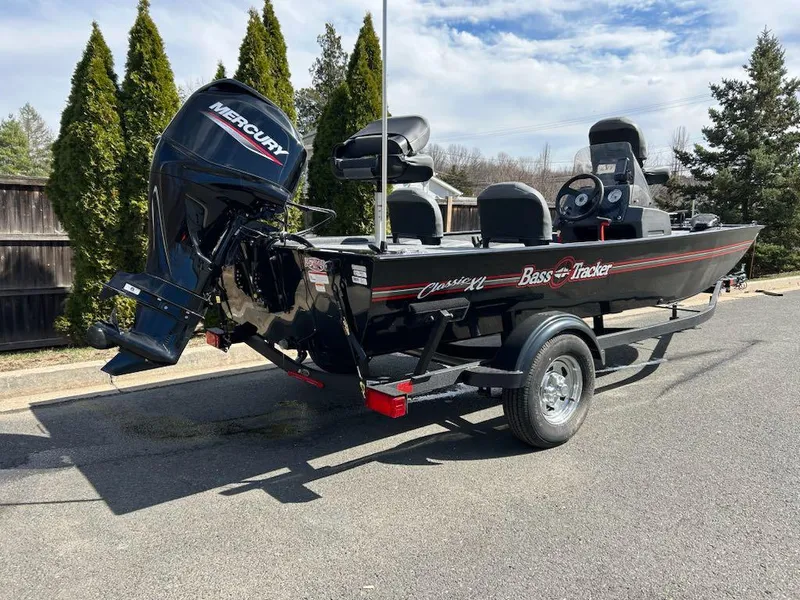 Slide: The Image of 2025 Tracker Bass Tracker Classic XL boat with Mercury engine on trailer. - 2