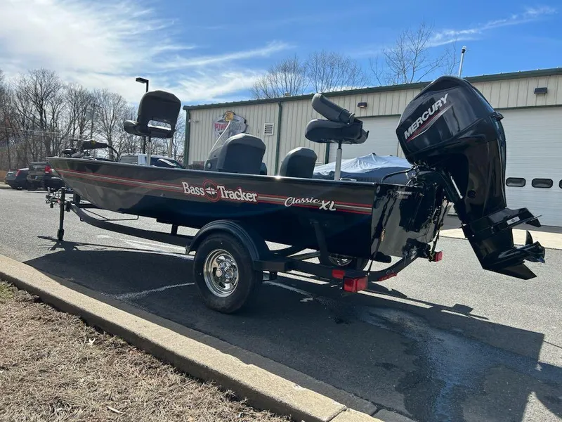 Slide: The Image of 2025 Tracker Bass Tracker Classic XL boat with Mercury engine parked outdoors. - 3