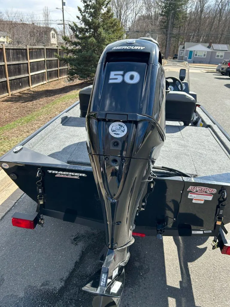 Slide: The Image of 2025 Tracker Bass Tracker Classic XL boat with Mercury 50 engine, parked outdoors. - 5