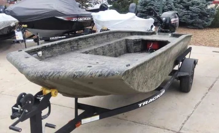 Slide: The Image of 2025 Tracker Grizzly 1650 T Prairie Wings Edition boat on trailer, outdoor setting. - 2