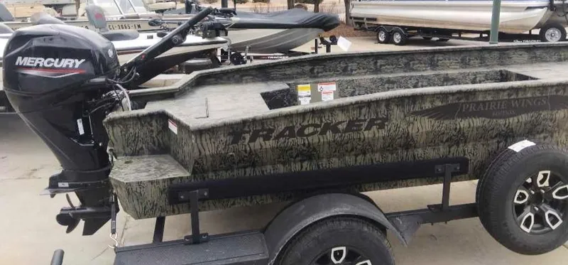 Slide: The Image of 2025 Tracker Grizzly 1650 T Prairie Wings Edition boat with Mercury engine on trailer. - 3