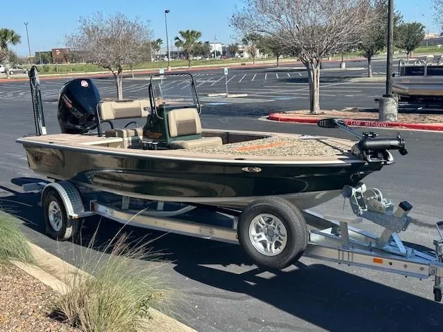 Slide: The Image of 2025 Mako 18 Pro Skiff Backwater Edition on trailer in parking lot. - 2