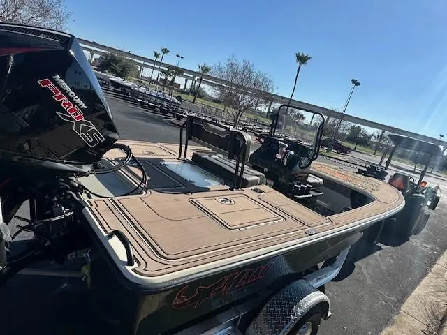 Slide: The Image of 2025 Mako 18 Pro Skiff Backwater Edition boat with powerful engine, parked outdoors. - 3