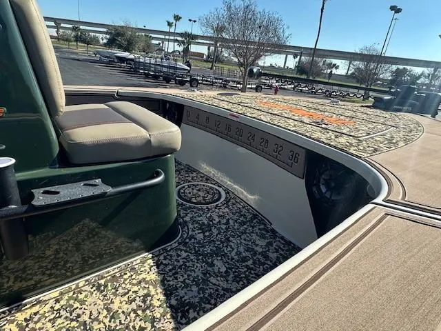 Slide: The Image of 2025 Mako 18 Pro Skiff Backwater Edition with camo interior and measuring ruler. - 4