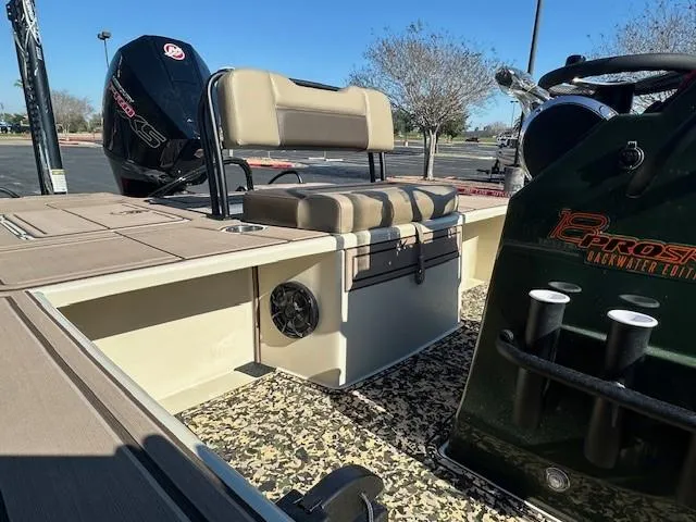 Slide: The Image of 2025 Mako 18 Pro Skiff Backwater Edition boat interior with seating and motor. - 6