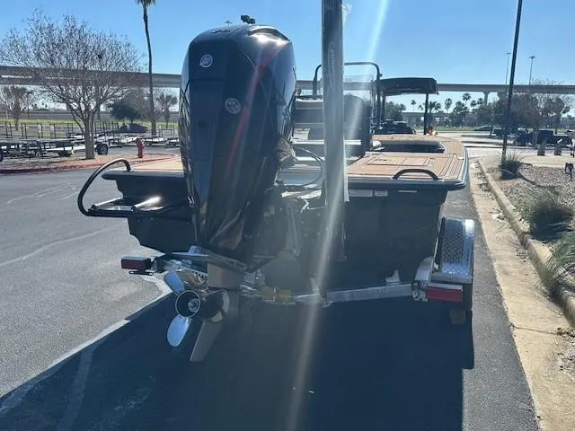 Slide: The Image of 2025 Mako 18 Pro Skiff Backwater Edition with outboard motor on trailer. - 7
