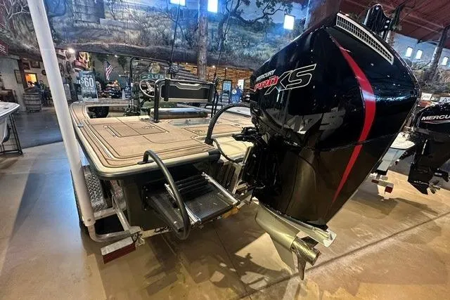 Slide: The Image of 2025 Mako 18 Pro Skiff Backwater Edition with powerful outboard motor in showroom. - 8