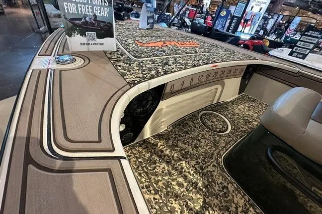 Slide: The Image of 2025 Mako 18 Pro Skiff Backwater Edition with camo deck and seating, displayed indoors. - 10