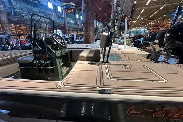 Slide: The Image of 2025 Mako 18 Pro Skiff Backwater Edition displayed indoors, showcasing seating and control console. - 12