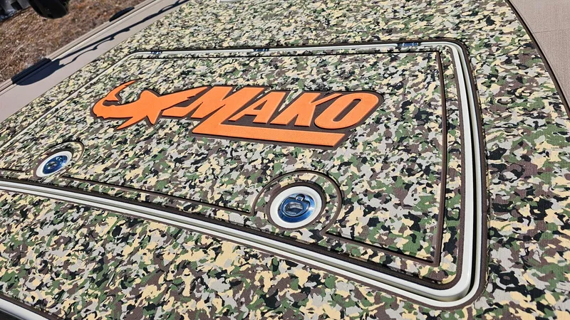 Slide: The Image of 2025 Mako 18 Pro Skiff Backwater Edition with camouflage design and bold orange logo. - 10