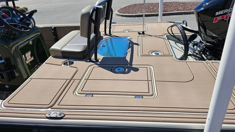 Slide: The Image of 2025 Mako 18 Pro Skiff Backwater Edition boat deck with seating and motor. - 11