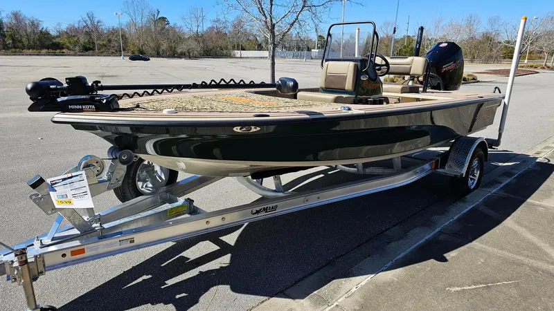 Slide: The Image of 2025 Mako 18 Pro Skiff Backwater Edition on trailer in parking lot. - 16