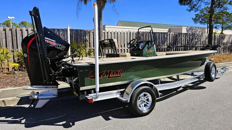 Slide: The Image of 2025 Mako 18 Pro Skiff Backwater Edition on trailer, parked outdoors. - 2