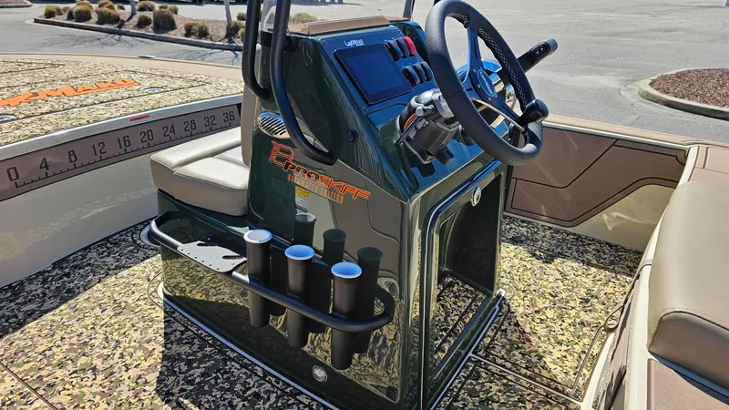 Slide: The Image of 2025 Mako 18 Pro Skiff Backwater Edition console with steering wheel and rod holders. - 8