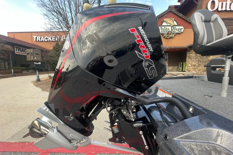 Slide: The Image of 2025 Nitro Z21 XL boat with Mercury Pro XS engine, parked outdoors near shops. - 3