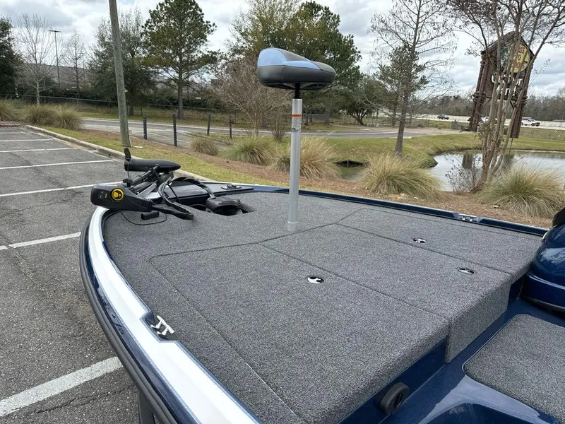 Slide: The Image of Nitro Z17 2025 boat with trolling motor in a parking lot near a pond. - 4