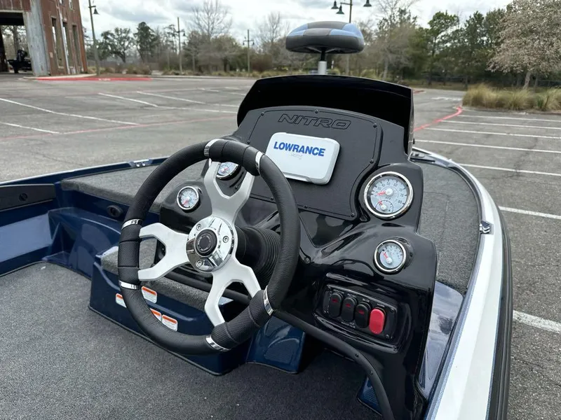 Slide: The Image of 2025 Nitro Z17 boat dashboard with steering wheel and Lowrance display. - 7