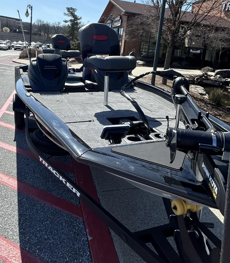 Slide: The Image of 2025 Tracker Pro Team 175 boat parked outdoors, showcasing sleek design and modern features. - 2