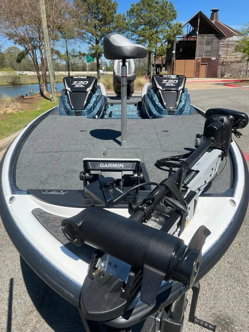 Slide: The Image of 2025 Nitro Z20 XL Pro boat with Garmin equipment, parked outdoors near a rustic building. - 4