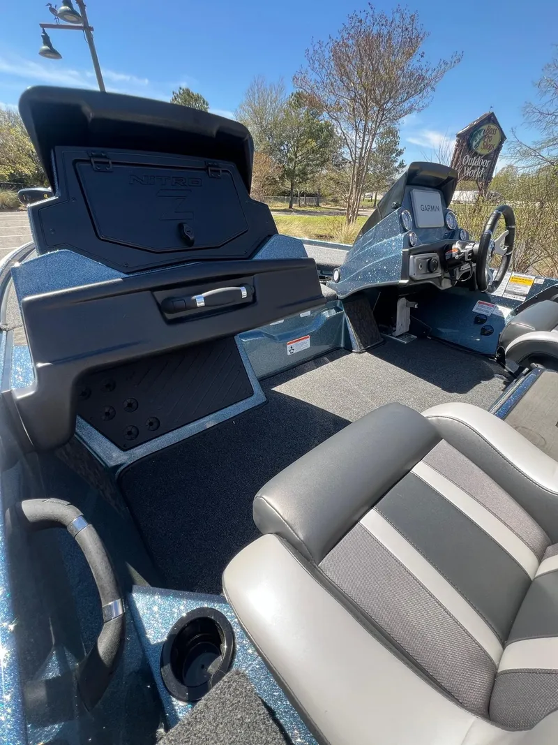 Slide: The Image of 2025 Nitro Z20 XL Pro boat interior with seating and control panel, under clear blue sky. - 6