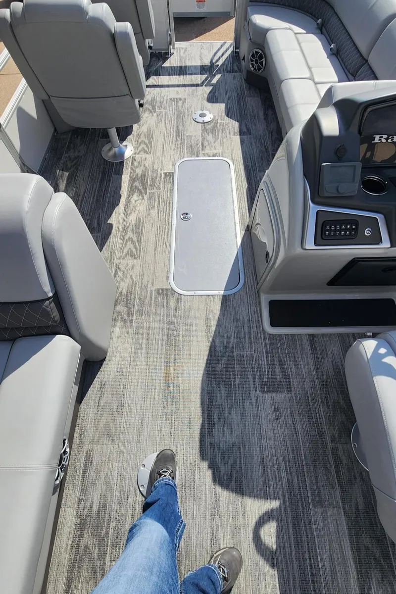 Slide: The Image of Interior view of 2025 Ranger Reata 223FC boat with gray seating and flooring. - 2