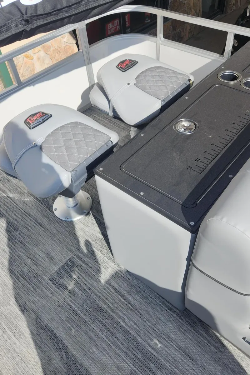 Slide: The Image of 2025 Ranger Reata 223FC boat interior with cushioned seating and storage. - 7