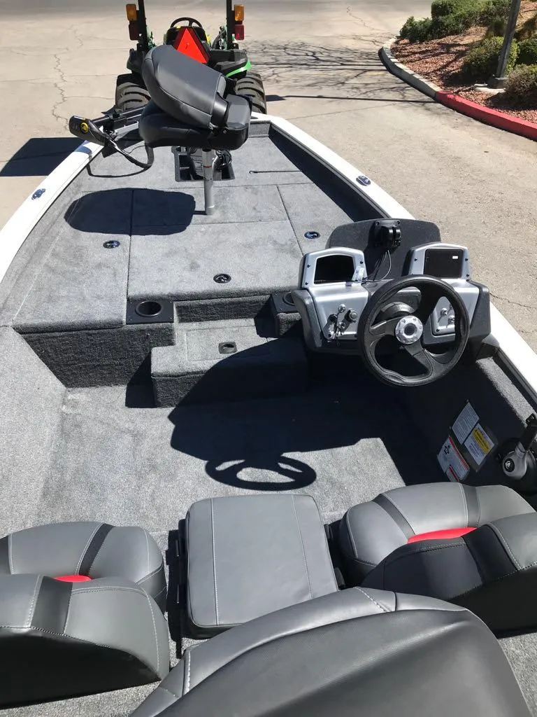 Slide: The Image of 2025 Tracker Pro Team 175 boat interior with steering console and seating. - 4