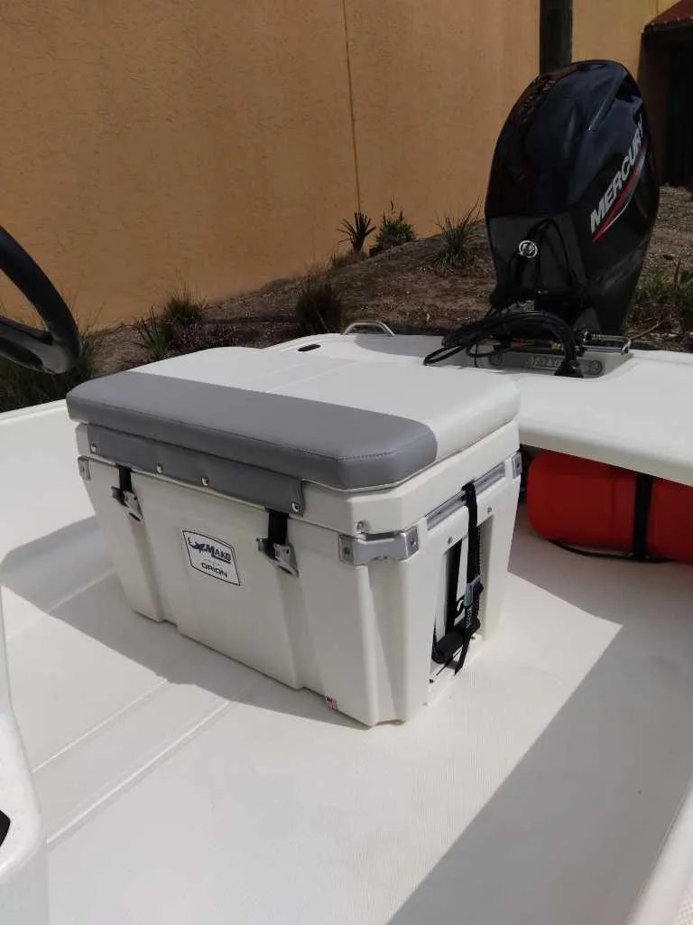 Slide: The Image of 2025 Mako Pro Skiff 15 CC boat with Mercury outboard motor and cushioned cooler seat. - 4