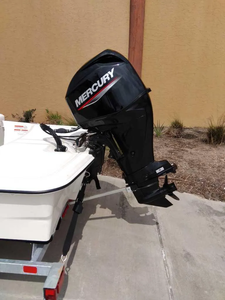 Slide: The Image of 2025 Mako Pro Skiff 15 CC with Mercury outboard motor on trailer. - 5