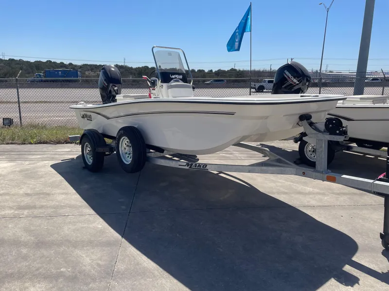The Image of 2025 Mako Pro Skiff 15 CC boat on trailer, parked outdoors under clear sky. - 0