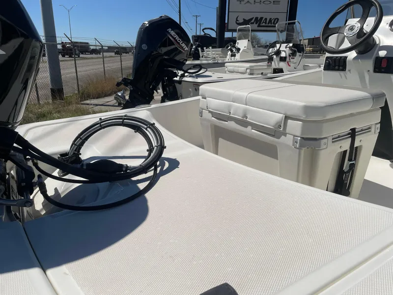 Slide: The Image of 2025 Mako Pro Skiff 15 CC boat interior with seating and steering wheel. - 4