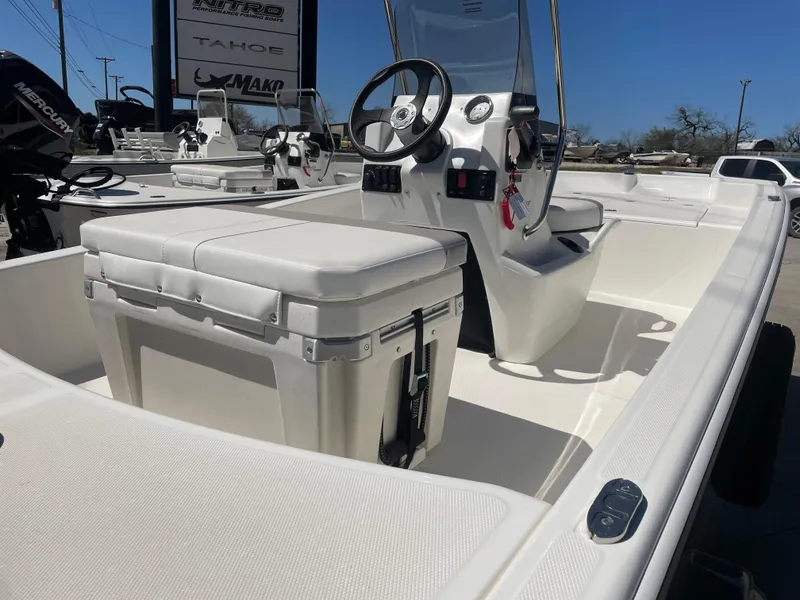 Slide: The Image of 2025 Mako Pro Skiff 15 CC boat interior with steering console and seating. - 5