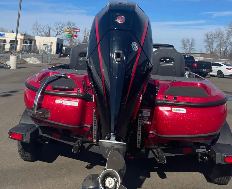 Slide: The Image of Red 2025 Nitro Z19 Pro boat with powerful outboard motor, parked outdoors. - 3