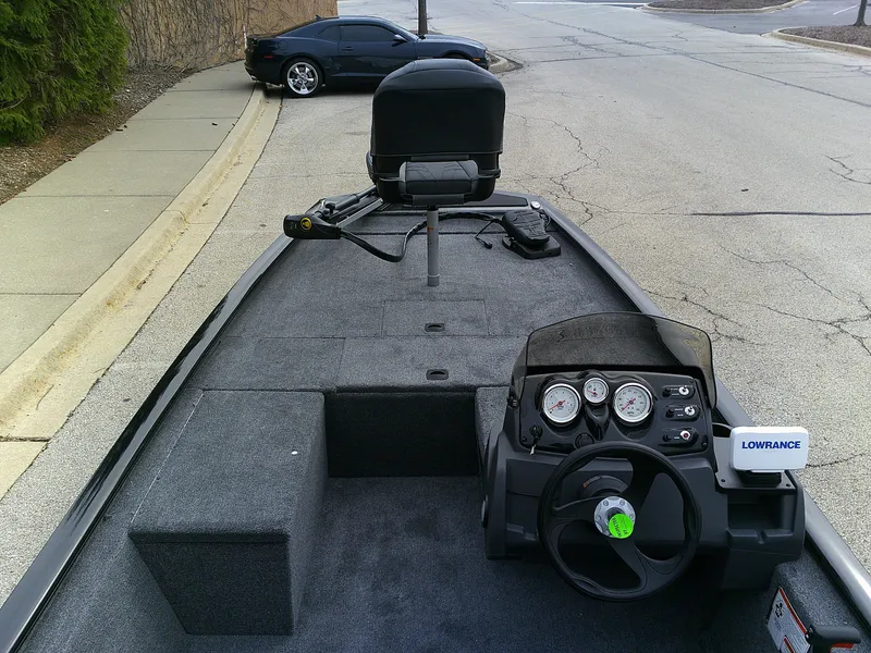 Slide: The Image of 2025 Tracker Pro 170 boat interior with steering wheel and Lowrance device. - 3