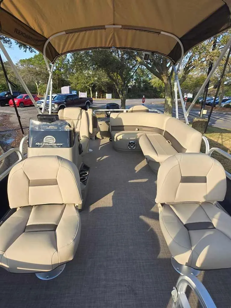 Slide: The Image of 2025 Sun Tracker Bass Buggy 18 DLX pontoon boat with spacious seating and canopy. - 2